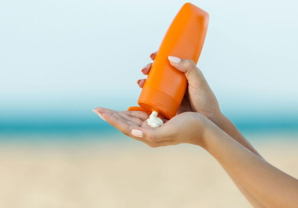 woman applying sunscreen